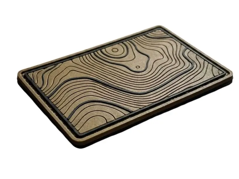 Tactical PVC patch featuring a topographic map design showing distinct flat layers of molded rubber.