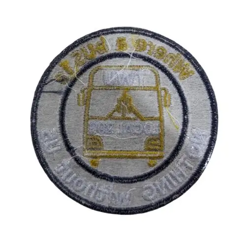 back side of embroidered patch showing iron-on heat seal backing