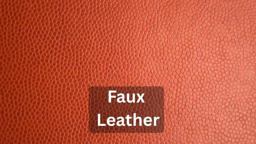 Macro texture shot of weather-resistant faux leather showing a uniform pebble grain pattern.