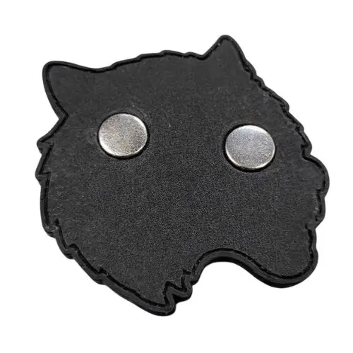 Back side of a custom wolf head PVC patch showing two strong circular magnets embedded flush into the rubber.