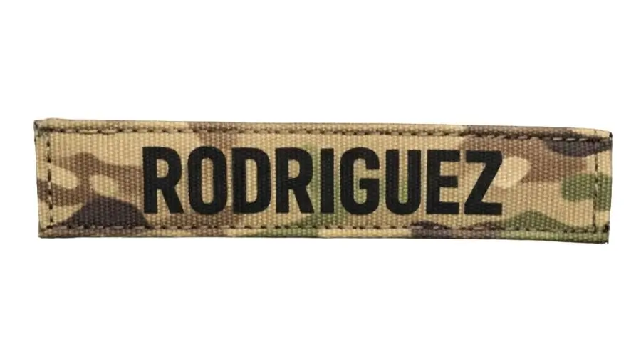 Custom printed tactical name tape with bold black text on MultiCam camouflage webbing.
