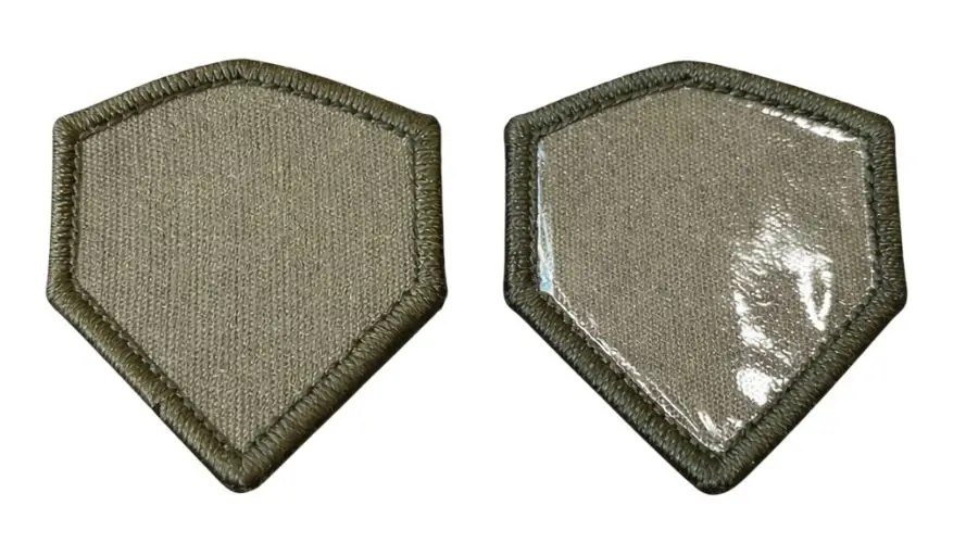Side-by-side comparison of raw sew-on backing versus glossy heat-seal iron-on adhesive on custom patches.