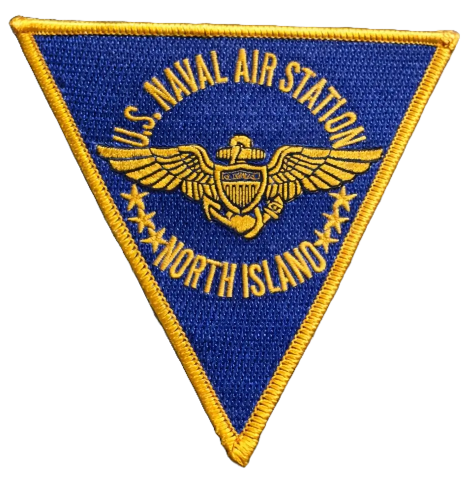 Custom embroidered triangular patch for U.S. Naval Air Station North Island featuring gold aviator wings on blue fabric.