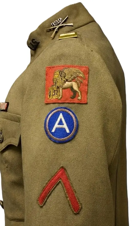 WWI military uniform sleeve showing a 332nd Infantry winged lion patch, Third Army insignia, and red chevron.